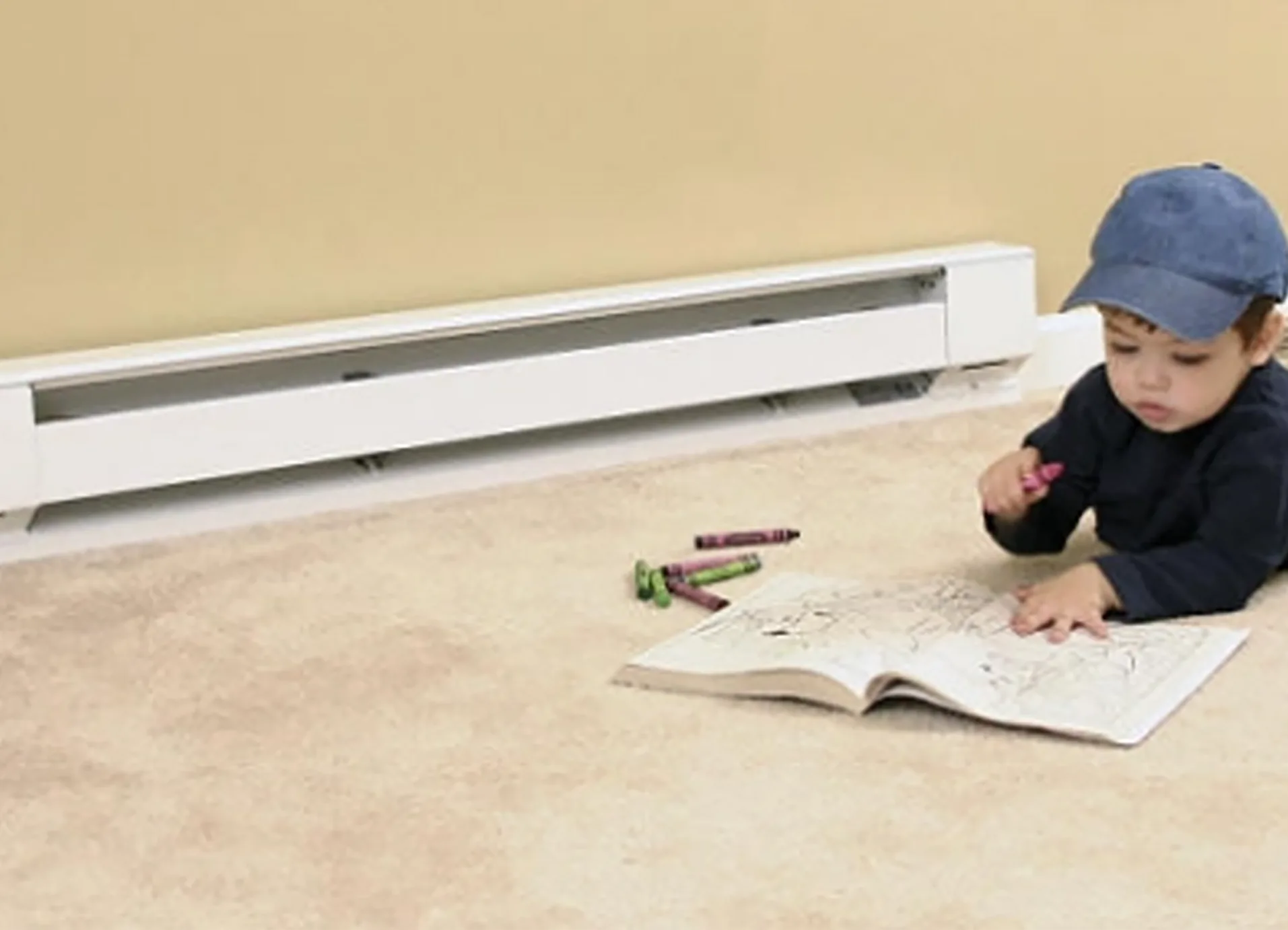 Technician installing an electric baseboard heater in a Calgary home