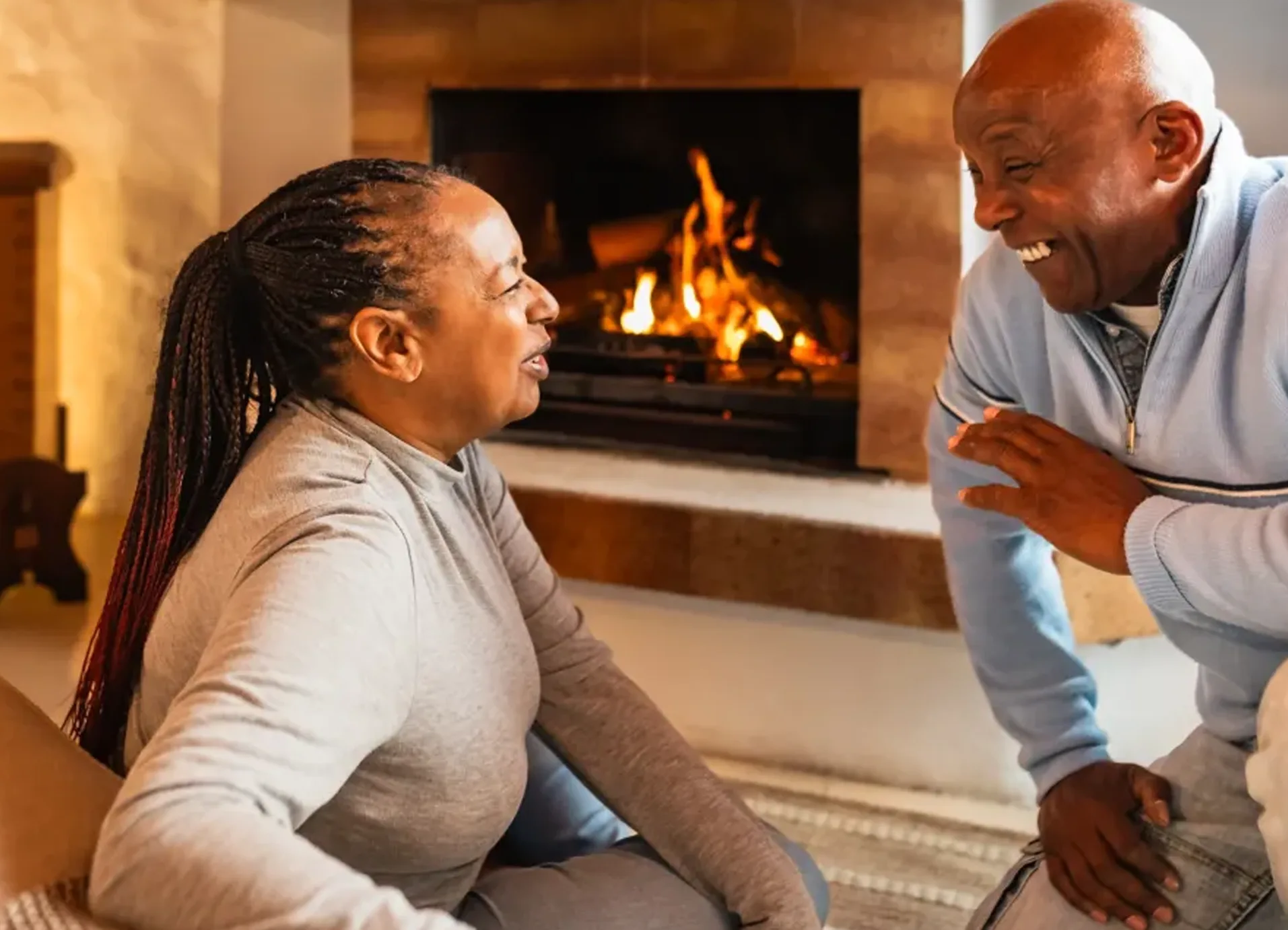 Technician performing maintenance on a gas fireplace in a Calgary, Alberta home