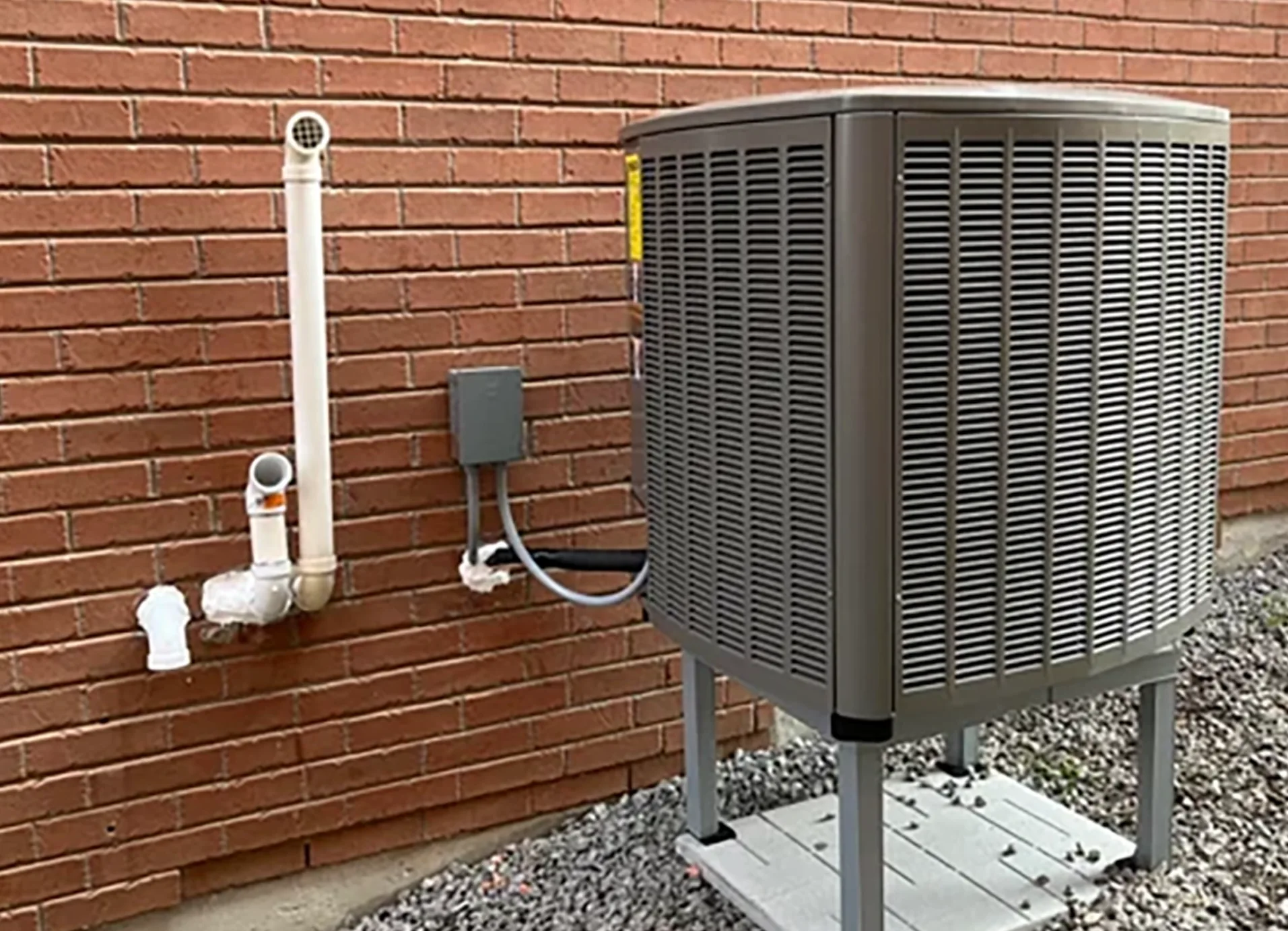 Technician configuring a dual-fuel hybrid heating system in a home for optimized energy use
