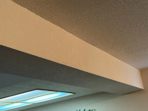 Completed drywall patch after Poly-B pipe replacement in a Calgary home